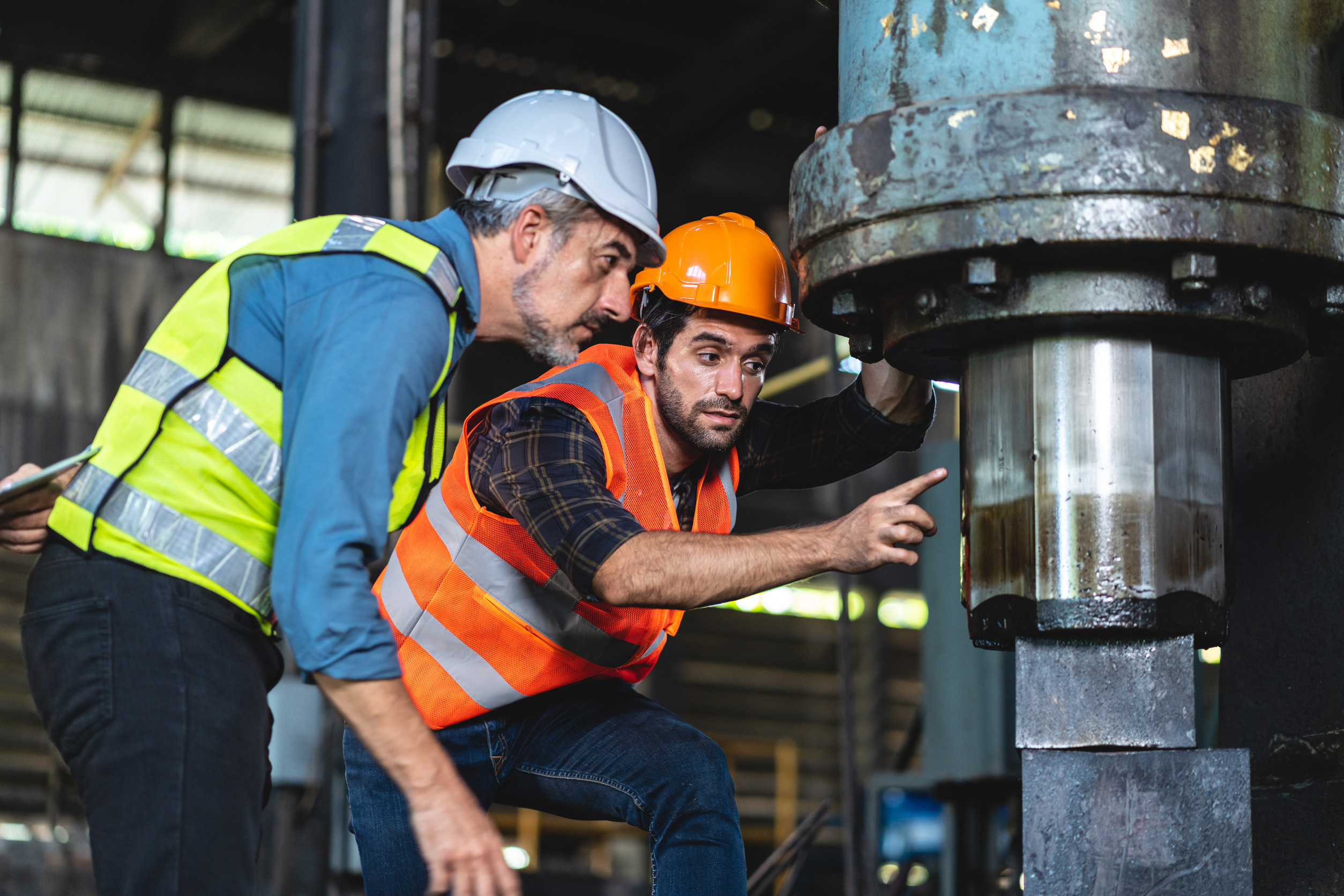 professional technician engineer with safety helmet hard hat working in industrial manufacturing factory, men at work to checking equipment of machinery production technology or construction operating